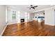 Open living room featuring hardwood floors, a fireplace, and natural light from windows and access to the kitchen at 913 Clayton Rd, Angier, NC 27501