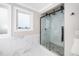 The luxurious shower features marble walls, a rainfall shower head, and a glass door at 913 Clayton Rd, Angier, NC 27501