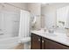 Cozy bathroom with a tub/shower combination, vanity, and a neutral color palette at 966 Shoofly Path, Apex, NC 27502