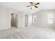 Neutral bedroom featuring a ceiling fan, plush carpet, and a large window at 966 Shoofly Path, Apex, NC 27502