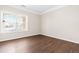 Bedroom with hardwood floors, trim and a window with blinds at 966 Shoofly Path, Apex, NC 27502