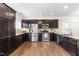 Spacious kitchen with stainless steel appliances, dark wood cabinets, and granite countertops at 966 Shoofly Path, Apex, NC 27502