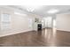 Spacious and well-lit living room featuring hardwood floors, a fireplace, and a view into the kitchen at 966 Shoofly Path, Apex, NC 27502
