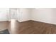 Empty room with hardwood floors, a view to another room and a white door at 966 Shoofly Path, Apex, NC 27502