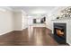 Bright living room with hardwood floors, a fireplace and open layout to the kitchen at 966 Shoofly Path, Apex, NC 27502