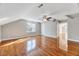 Large bedroom boasting gleaming hardwood floors, ample natural light, and a ceiling fan at 100 Pebble Ridge Farms Ct, Cary, NC 27513