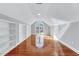 Bright bedroom featuring built in shelving and gleaming hardwood floors at 100 Pebble Ridge Farms Ct, Cary, NC 27513