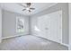 Carpeted bedroom with a window, large closet and neutral walls at 100 Pebble Ridge Farms Ct, Cary, NC 27513