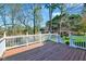 Wooden deck overlooking a lush, green landscape with mature trees and vegetation at 100 Pebble Ridge Farms Ct, Cary, NC 27513