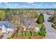 Well-maintained home with brick facade, manicured lawn, and mature trees along the street at 100 Pebble Ridge Farms Ct, Cary, NC 27513