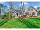 Charming brick home with a well-manicured lawn, mature trees, and inviting curb appeal at 100 Pebble Ridge Farms Ct, Cary, NC 27513