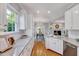 Bright, open kitchen boasts white cabinets, granite countertops, and hardwood floors at 100 Pebble Ridge Farms Ct, Cary, NC 27513