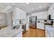 Well-lit kitchen with granite countertops, stainless steel appliances, and white cabinetry at 100 Pebble Ridge Farms Ct, Cary, NC 27513