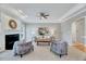 Cozy living room features a fireplace, plush seating, and natural light at 100 Pebble Ridge Farms Ct, Cary, NC 27513