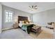 Spacious main bedroom with a decorative headboard and two windows at 100 Pebble Ridge Farms Ct, Cary, NC 27513