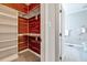 Cedar walk-in closet with shelves, wooden rods, and adjacent bathroom at 100 Pebble Ridge Farms Ct, Cary, NC 27513