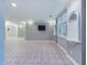 Spacious finished basement with tile flooring, a flat screen TV, and ample lighting, ideal for recreation at 101 Sundance Pl, Chapel Hill, NC 27514