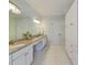 Bathroom with granite vanity, white cabinets, and a large mirror at 101 Sundance Pl, Chapel Hill, NC 27514