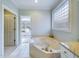 Bright bathroom features a jetted tub beneath a glass block window at 101 Sundance Pl, Chapel Hill, NC 27514