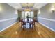 Formal dining room is spacious and features hardwood floors, elegant lighting, and large windows at 101 Sundance Pl, Chapel Hill, NC 27514