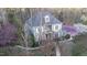 Two-story home with white windows in a wooded area, showing a balcony and manicured front yard at 101 Sundance Pl, Chapel Hill, NC 27514