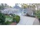 Well-kept home with a long driveway and blooming white trees at 101 Sundance Pl, Chapel Hill, NC 27514
