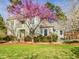 Beautiful two-story home with a well-maintained lawn and lush landscaping, including flowering trees at 101 Sundance Pl, Chapel Hill, NC 27514