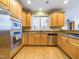 Spacious kitchen features stainless appliances, light wood cabinets, granite countertops and hardwood floors at 101 Sundance Pl, Chapel Hill, NC 27514