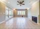 Large living room with fireplace, tile floors, double doors, and lots of natural light at 101 Sundance Pl, Chapel Hill, NC 27514