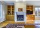 Living room features built-in cabinetry flanking the fireplace and wood flooring at 101 Sundance Pl, Chapel Hill, NC 27514