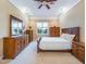 Cozy primary bedroom with wood furnishings, plush carpet, and a ceiling fan, exuding warmth and comfort at 101 Sundance Pl, Chapel Hill, NC 27514