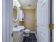 Compact powder room with a modern sink, toilet, and a stylish black marble-patterned floor at 101 Sundance Pl, Chapel Hill, NC 27514