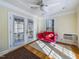 Cozy sunroom with a bright pink sofa, French doors, and large windows providing natural light at 101 Sundance Pl, Chapel Hill, NC 27514