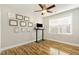 Bedroom featuring wood floors, a ceiling fan, a window, and wall decorations at 10411 Rosegate Ct # 202, Raleigh, NC 27617