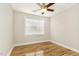 Empty bedroom featuring wood-look floors, white walls, a ceiling fan, and a window at 10411 Rosegate Ct # 202, Raleigh, NC 27617