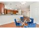 Dining area with hardwood floors, modern lighting, a glass table, and dark blue chairs near the kitchen at 10411 Rosegate Ct # 202, Raleigh, NC 27617