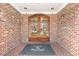 Inviting brick entrance with double doors and 'Cascades Brier Creek' mat at 10411 Rosegate Ct # 202, Raleigh, NC 27617