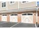 Three garages with white carriage style doors and black hardware at 10411 Rosegate Ct # 202, Raleigh, NC 27617