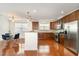 Bright kitchen with wood cabinets, stainless steel appliances, and an adjacent dining area at 10411 Rosegate Ct # 202, Raleigh, NC 27617