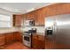 Close up of kitchen featuring stainless steel appliances, granite countertops, and wood cabinets at 10411 Rosegate Ct # 202, Raleigh, NC 27617