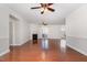 Spacious living room with hardwood floors, neutral walls, fireplace, ceiling fans, and access to other rooms at 10411 Rosegate Ct # 202, Raleigh, NC 27617