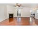 Well-lit living room featuring hardwood floors, a fireplace, ceiling fan, and sliding glass door to the exterior at 10411 Rosegate Ct # 202, Raleigh, NC 27617