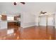 Open living room with hardwood floors, ceiling fan, leading to a kitchen area with wood cabinets and stainless steel appliances at 10411 Rosegate Ct # 202, Raleigh, NC 27617
