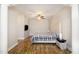 Spacious main bedroom with wood floors, neutral walls, large bed, and accent pillars at 10411 Rosegate Ct # 202, Raleigh, NC 27617