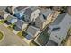 Aerial view of home with fenced yard, detached garage, patio, and playset at 105 Della St, Chapel Hill, NC 27516