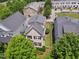 Aerial view of the home showcasing its backyard, neighborhood, and lush greenery surrounding the property at 105 Della St, Chapel Hill, NC 27516