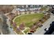 Aerial view of park and townhomes showcase community greenspace and surrounding neighborhood at 105 Della St, Chapel Hill, NC 27516