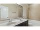 Well-lit bathroom showcasing a double vanity with marble countertop and a shower-tub combo at 105 Della St, Chapel Hill, NC 27516