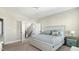 Well-lit bedroom featuring carpeted floors and a view of a staircase through an open door at 105 Della St, Chapel Hill, NC 27516