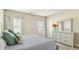Bright bedroom featuring plush bedding, ample natural light, and a dresser with decorative vase at 105 Della St, Chapel Hill, NC 27516